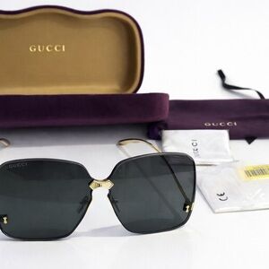 Gucci Women's Sunglasses in Black with Gold Accents